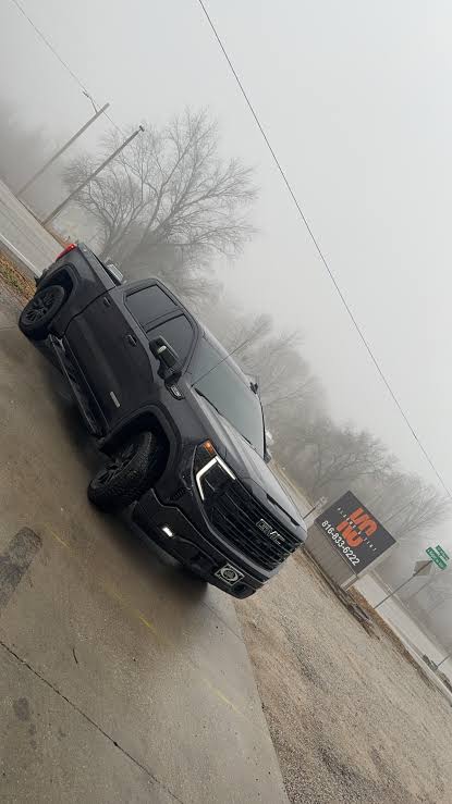 Dark gray GMC pickup truck completed with vehicle window tint at Alarms & Tint KC