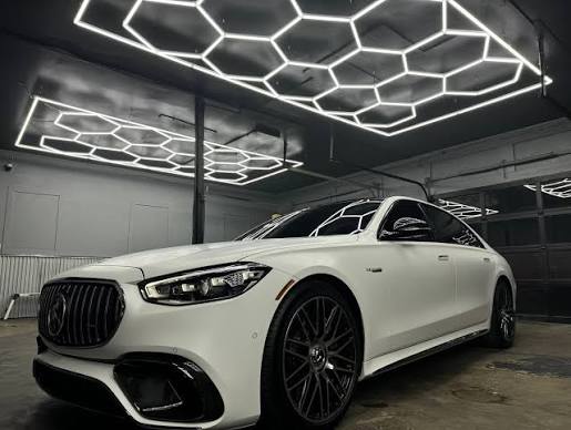 White Mercedes-Benz sedan in the shop