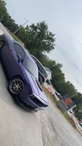 Purple Dodge Challenger outside following custom window tint service at our shop