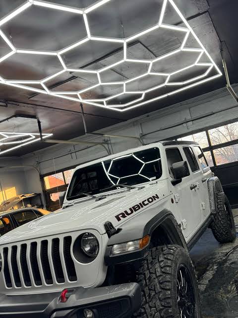 White Jeep Rubicon in the shop bay